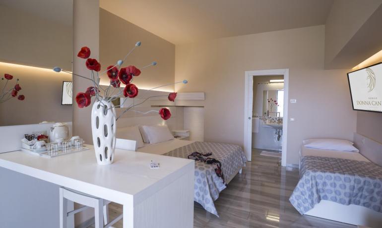 Modern room with red flowers, cozy and bright atmosphere.